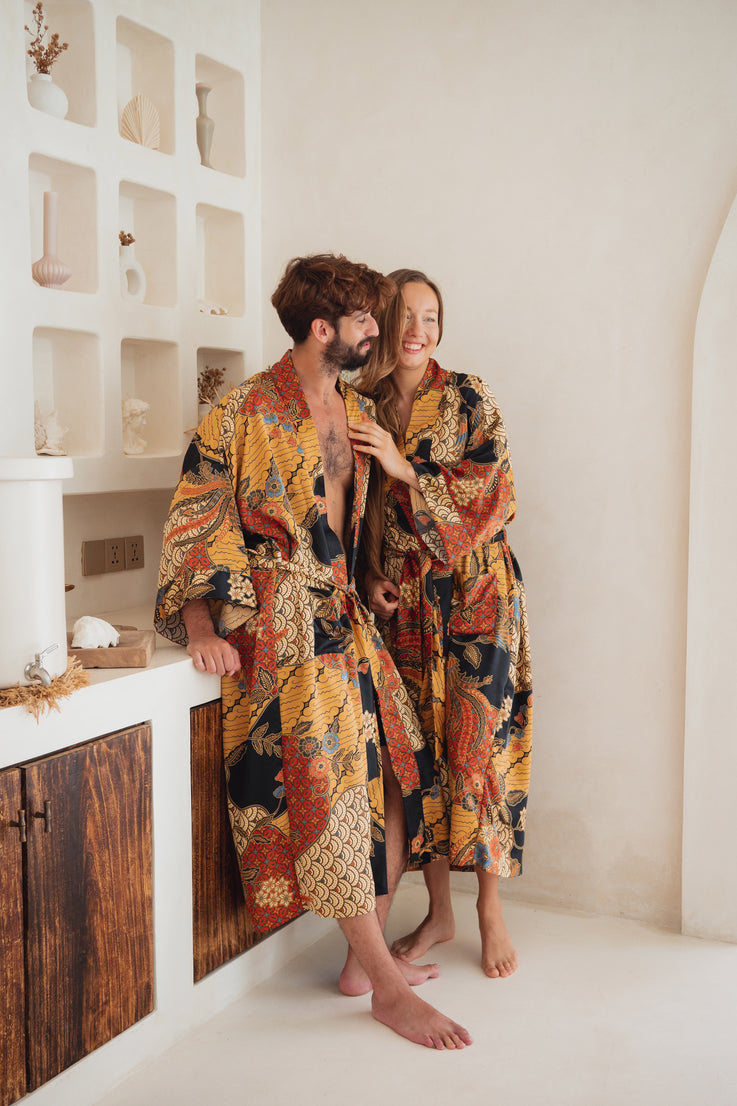A couple wearing Balinese orange/yellow/black Silk Kimono Robe
