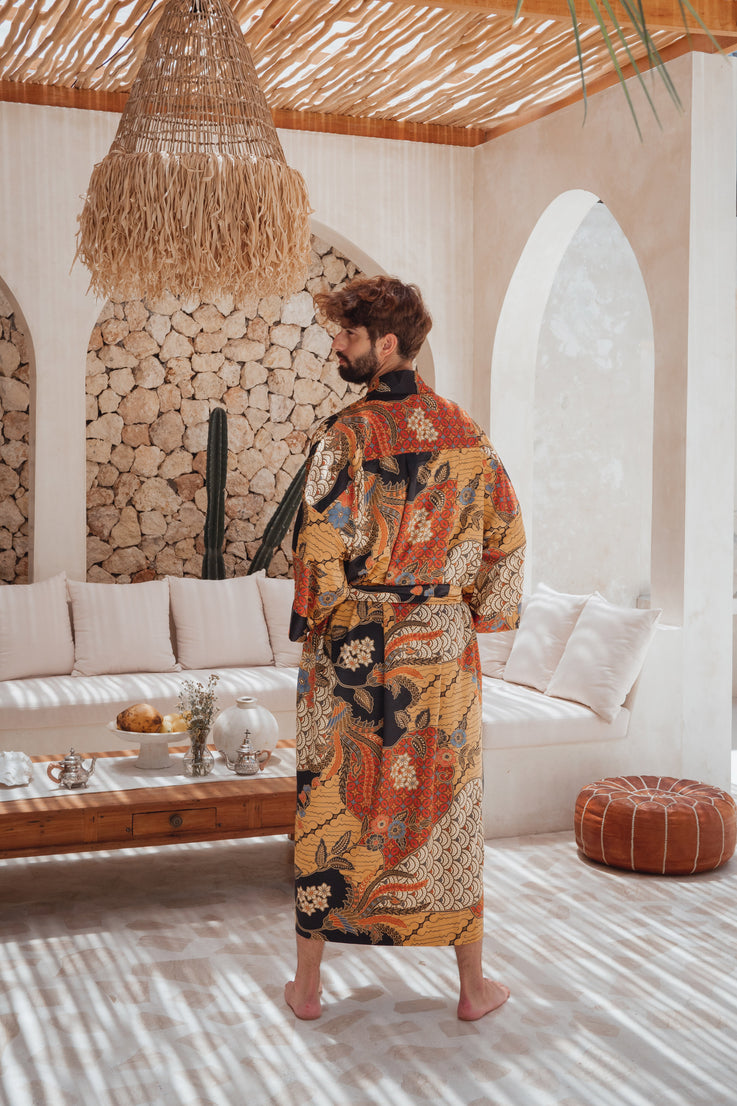 A man wearing Balinese orange/yellow/black Silk Kimono robe