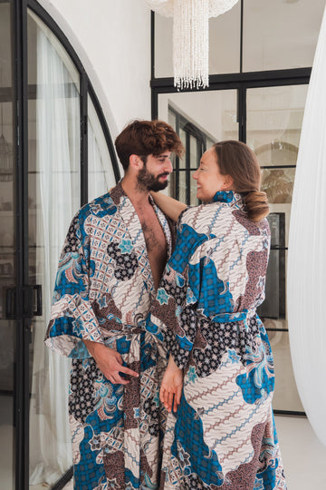 a couple looking at each other and  wearing blue and white floral silk kimono  robes 